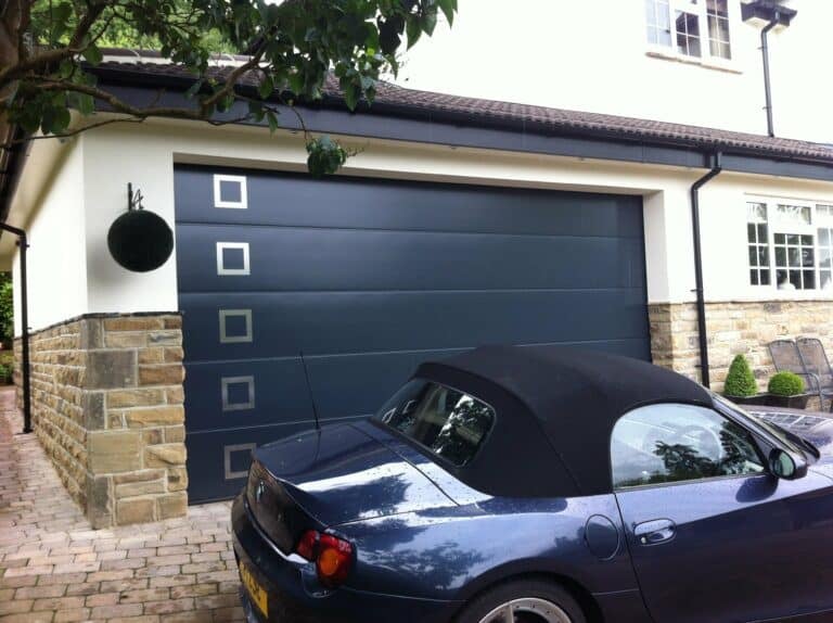 Hormann L-Ribbed Sectional in Anthracite Grey with Stainless Steel Design Element Style 451 By ABi Garage Doors