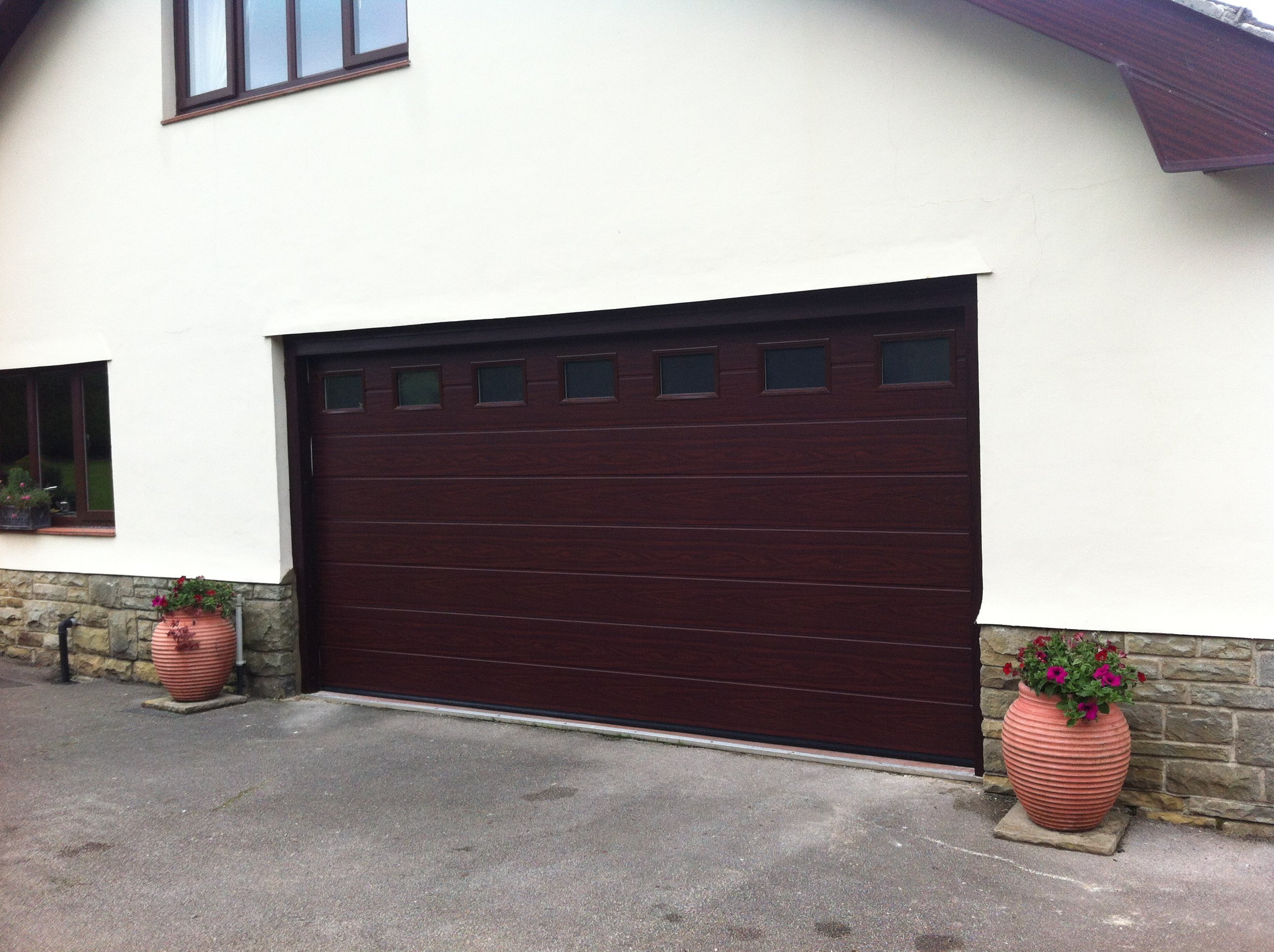 Hormann M Ribbed Sectional in Decograin Rosewood with Glazing By ABi Garage Doors