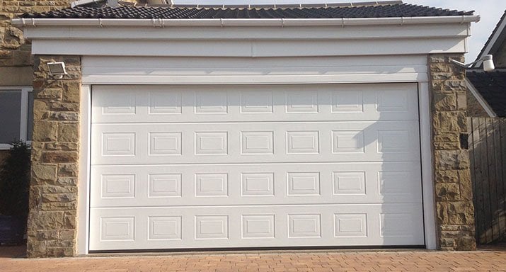 Fully automatic Hörmann made to measure LPU40 insulated Georgian design sectional door, including a low headroom kit, installed in Pannal, Harrogate.
