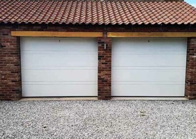 Double Garage with Single Double Ribbed Sectional Garage Doors in White