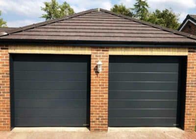 Double Garage with Single Medium Ribbed Sectional Garage Doors in Black