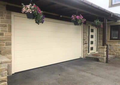 Cream Medium Ribbed Sectional Garage Door with Matching Steel Entrance Door