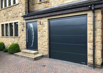 Black Large Ribbed Sectional Door with Matching Steel Entrance Door