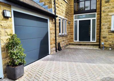 Large Ribbed Anthracite Grey Sectional Door with Matching Steel Entrance Door