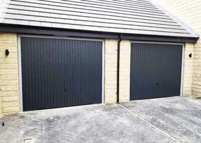 Two Black Single Up and Over Doors on a Double Garage
