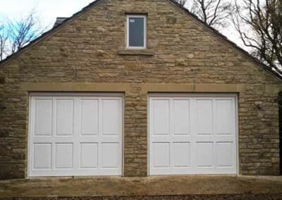Wooden Single White Up and Over Garage Doors on Double Garage