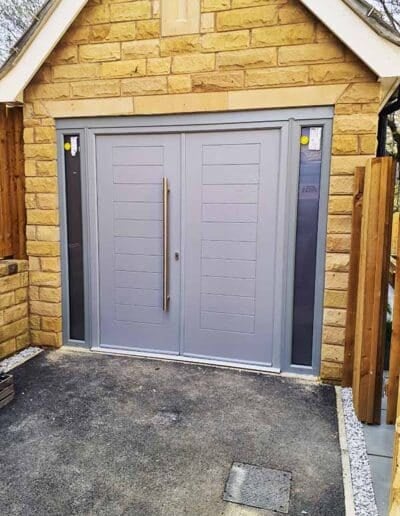 Light grey side hinged garage door with long bar handle