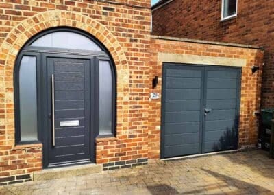 Anthracite grey side hinged garage door with matching composite front door