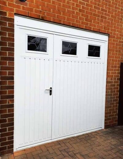 Side-hinged garage door in metal, finished in white