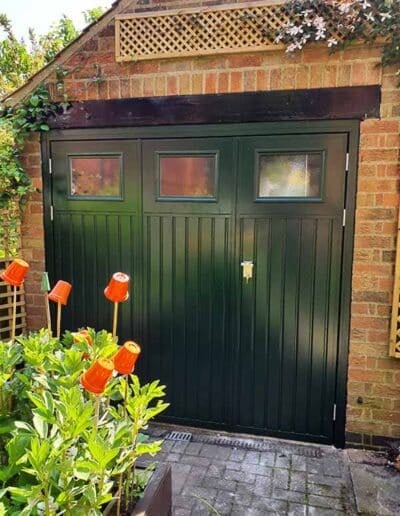 Steel non-insulated side hinged garage door in green