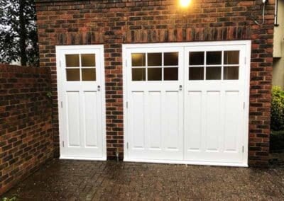 White side hinged garage door with windows constructed from wood